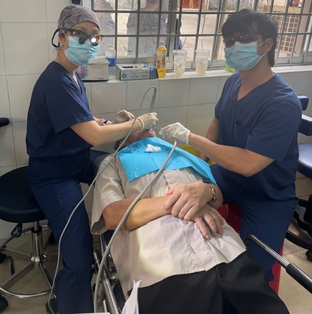 Luc Tran assisting with dental care